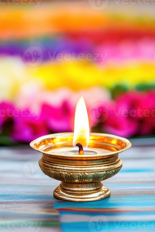 Traditional Nilavilakku brass lamp with flickering flames placed centrally in a vibrant Pookalam, creating a warm and spiritual glow during a festive celebration photo