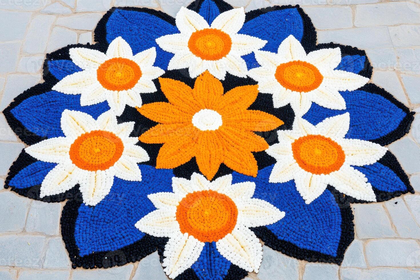 Colorful Pookalam design reflecting tradition in a temple courtyard during the Onam celebration photo