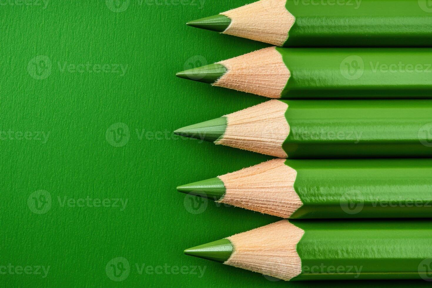 Collection of green pencils arranged in a row showcasing sharp tips and smooth wooden texture perfect for artists and creative projects photo