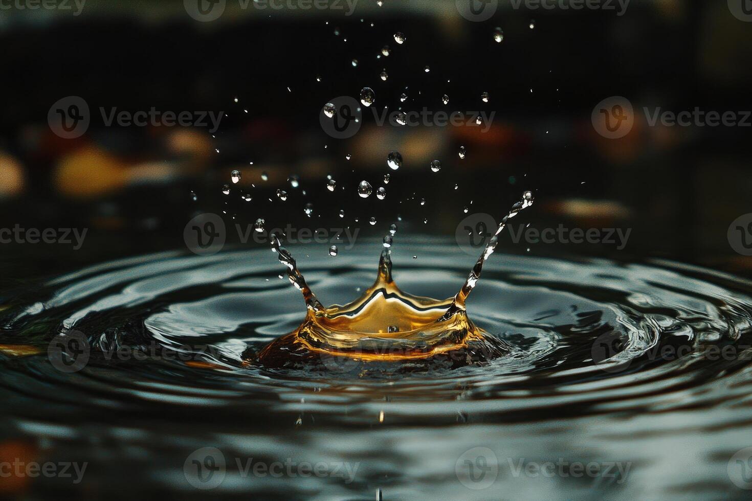 Golden water crown splashing and creating ripples on a dark water surface photo