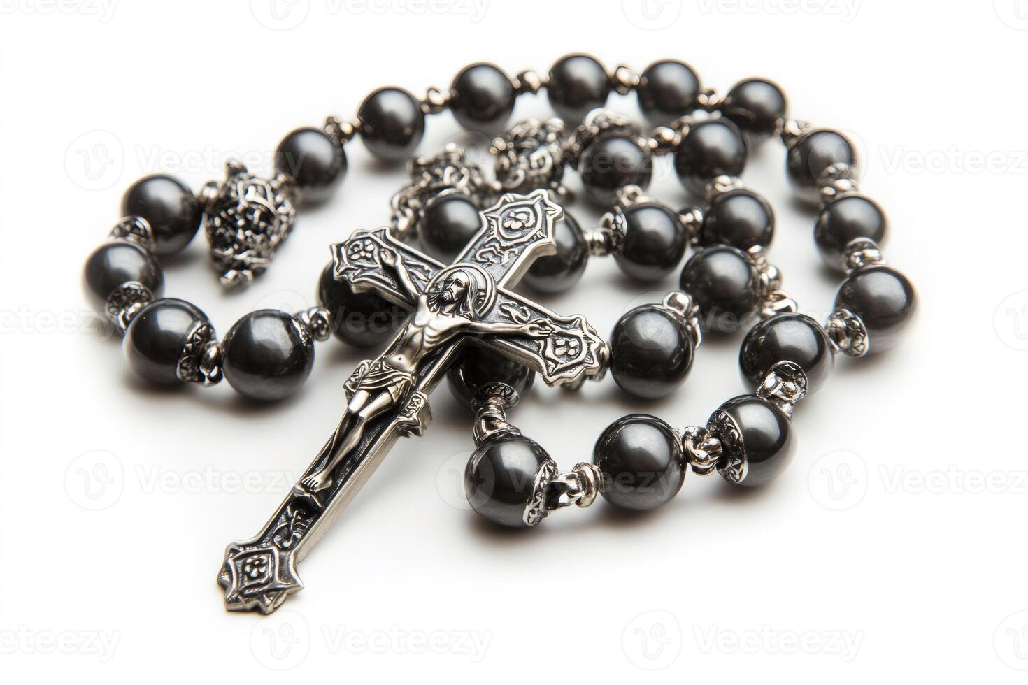 Rosary with silver crucifix resting on white background photo