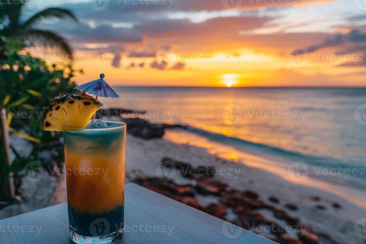 Refreshing cocktail with pineapple slice is waiting on beachfront bar during amazing sunset photo