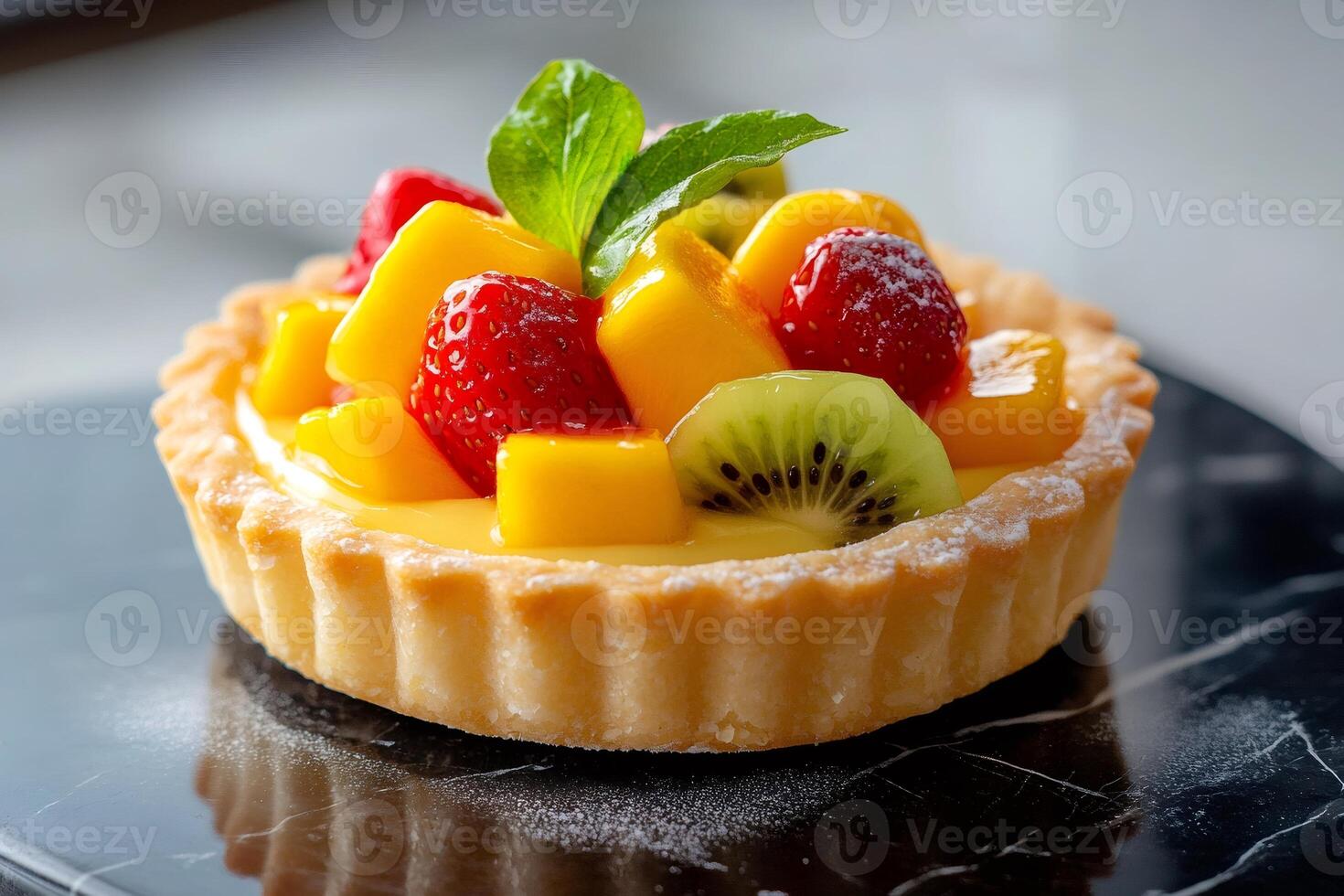 Delicious fruit tart with mango, kiwi and strawberries garnished with mint leaf photo