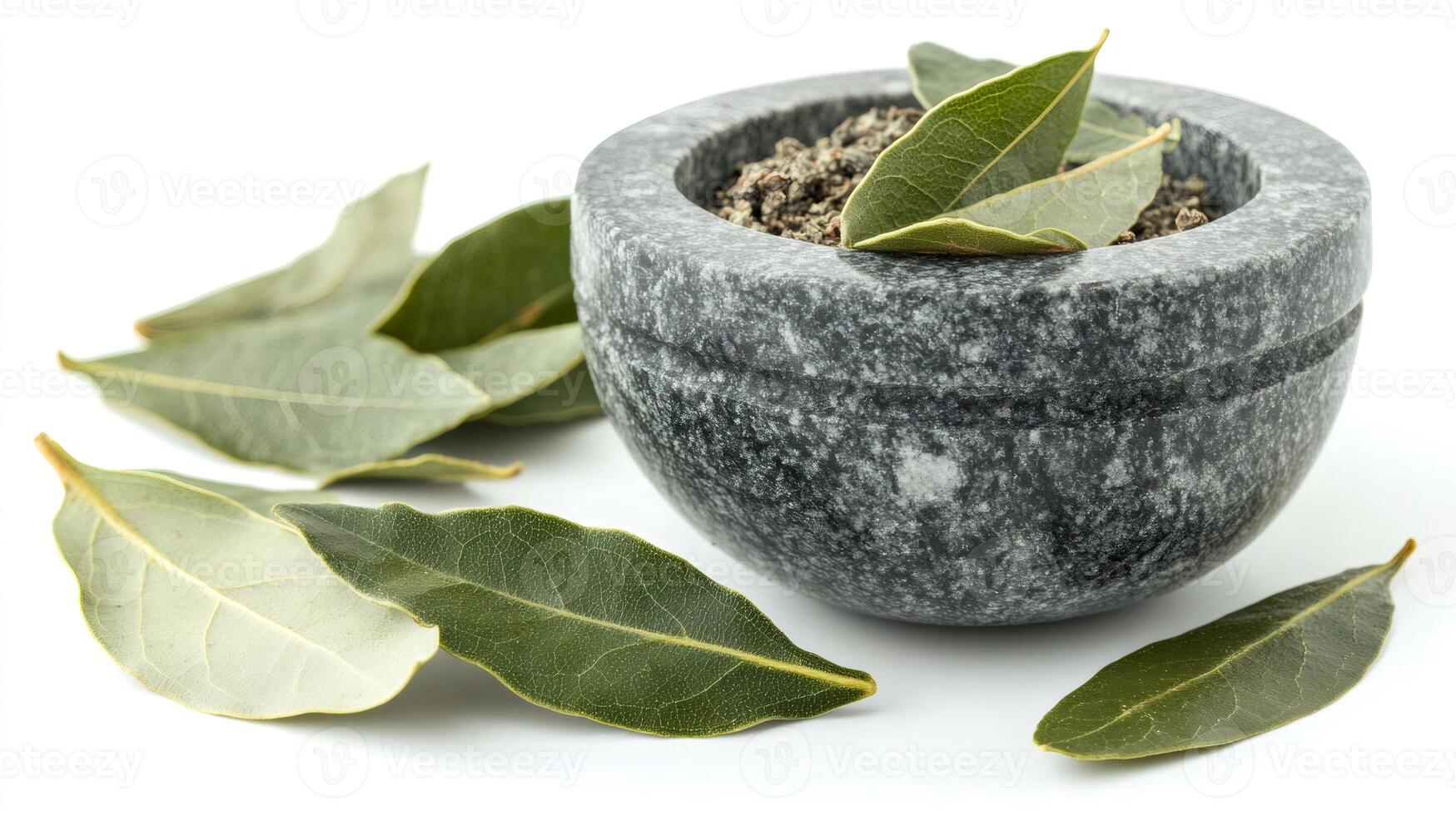 Ground bay leaf with fresh bay leaves in a gray stone mortar photo