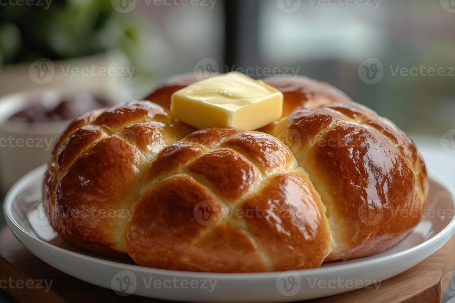 Buttery brioche bread resting on white plate with jam in the background photo