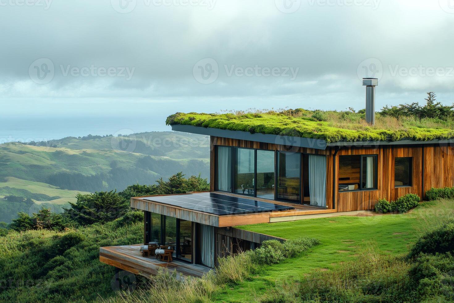Modern sustainable green roof house with solar panels overlooking the ocean photo