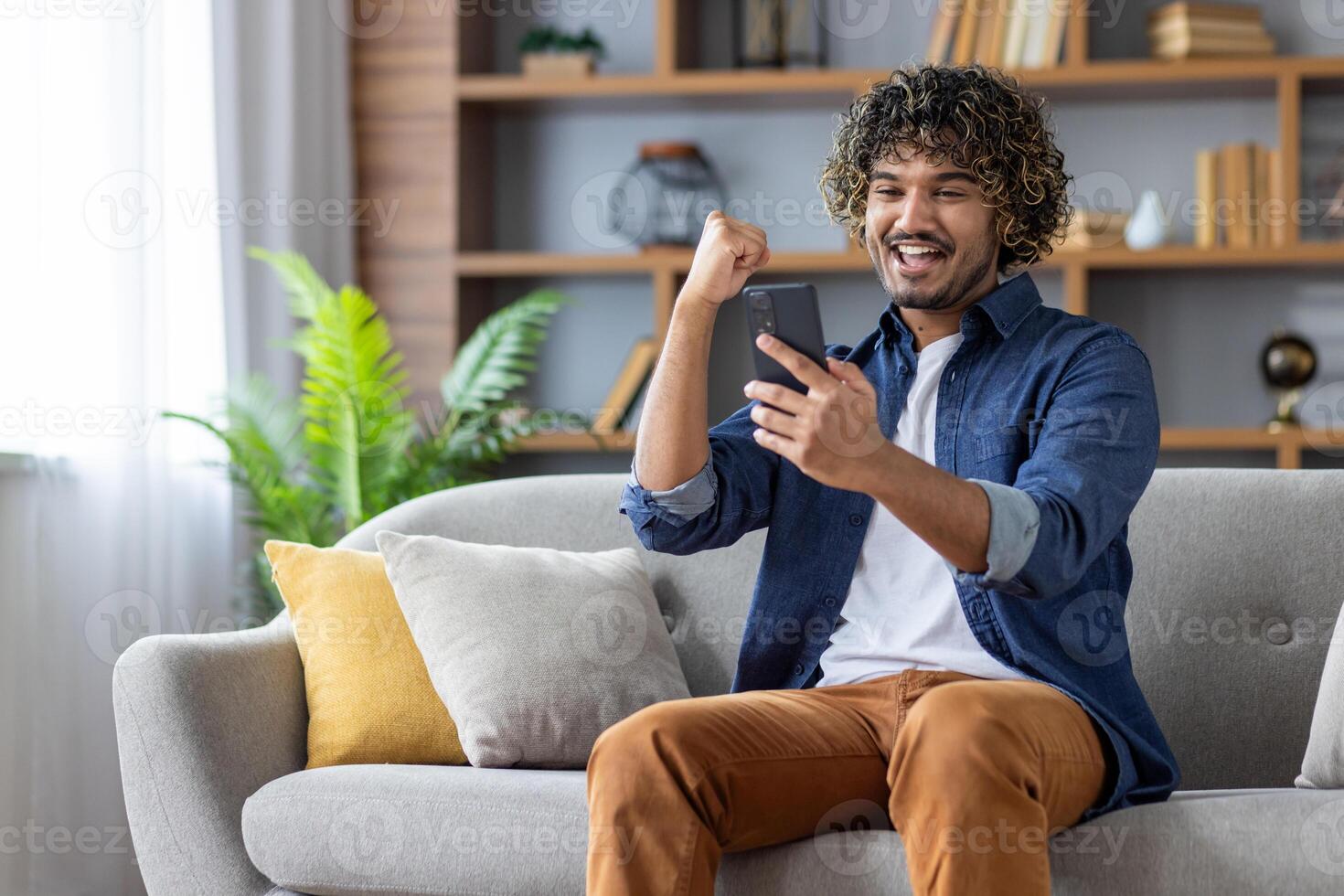 Confident professional man wearing headset in modern office engaged in conference. Gesturing with hands, focused expression indicating thoughtful communication with team photo