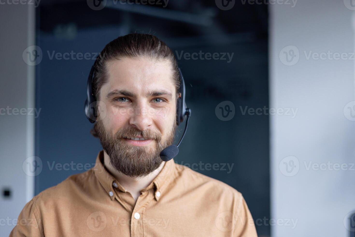 Professional customer support agent wearing a headset, smiling warmly in a modern workplace setting. photo