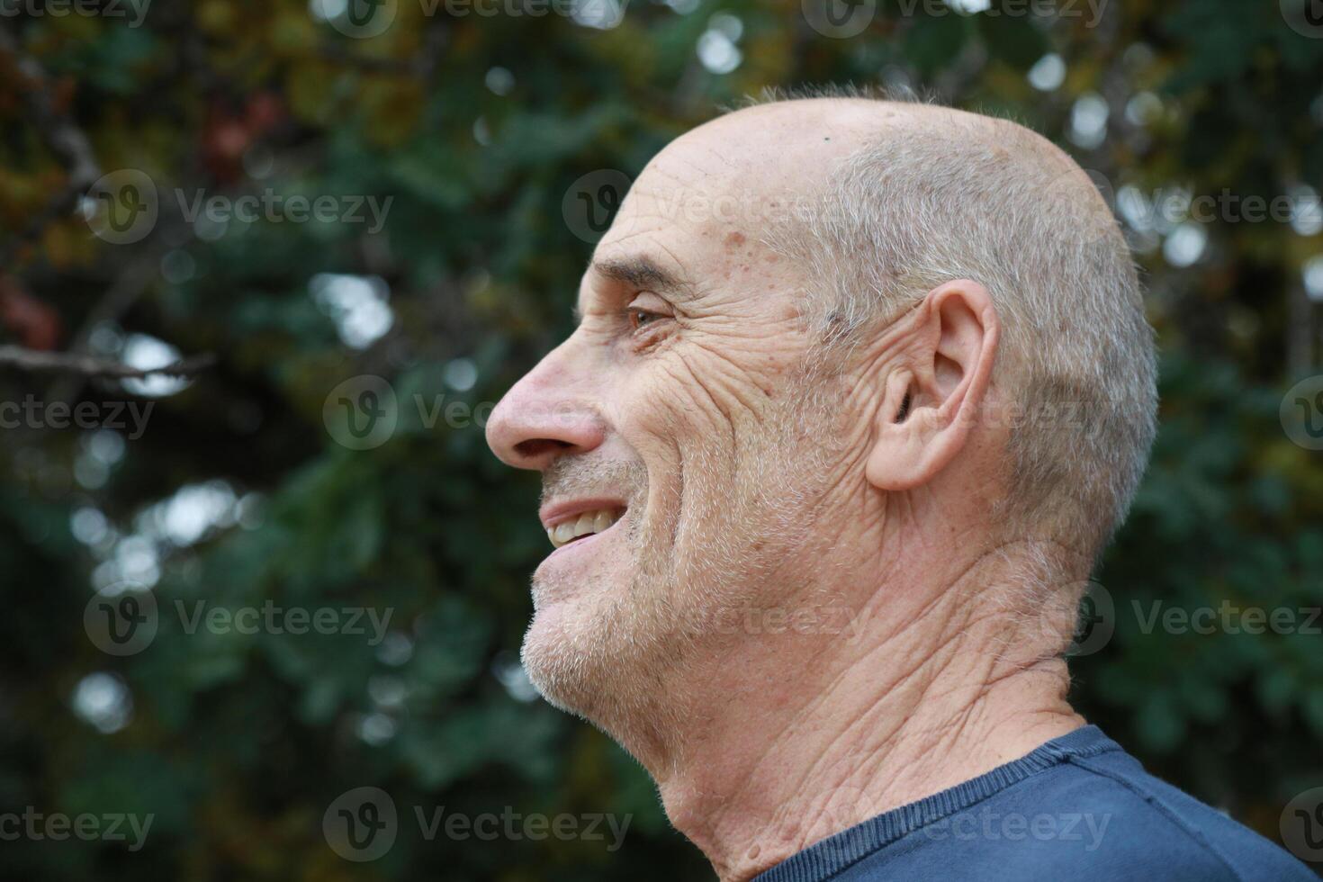 Elderly Man Smiles Talking With His Friend In The Natural Park photo