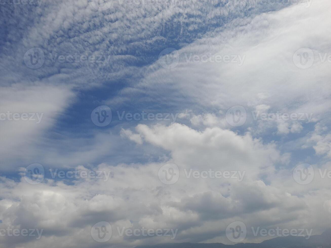 Light blue sky with clouds, can be used as a background. photo