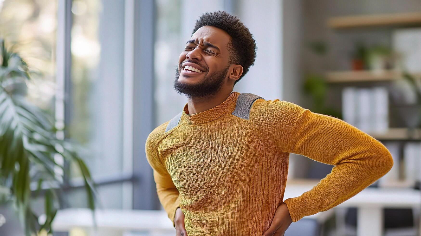 A man with back pain in an office photo
