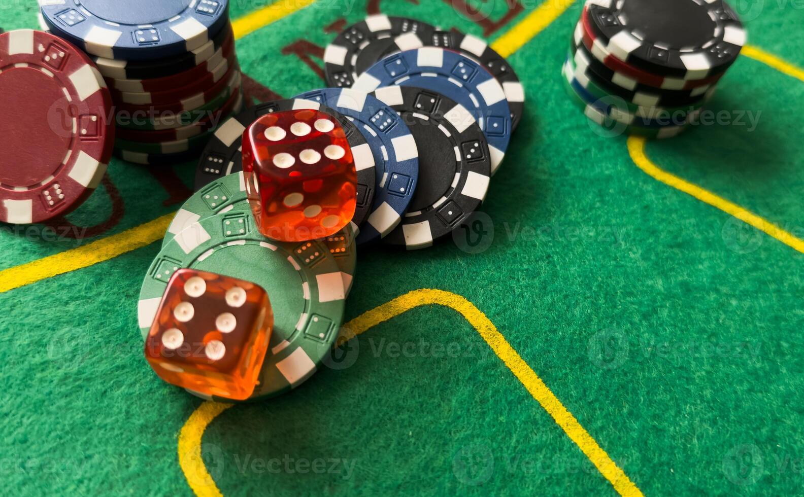 Rolling red dice on a casino table with chips photo