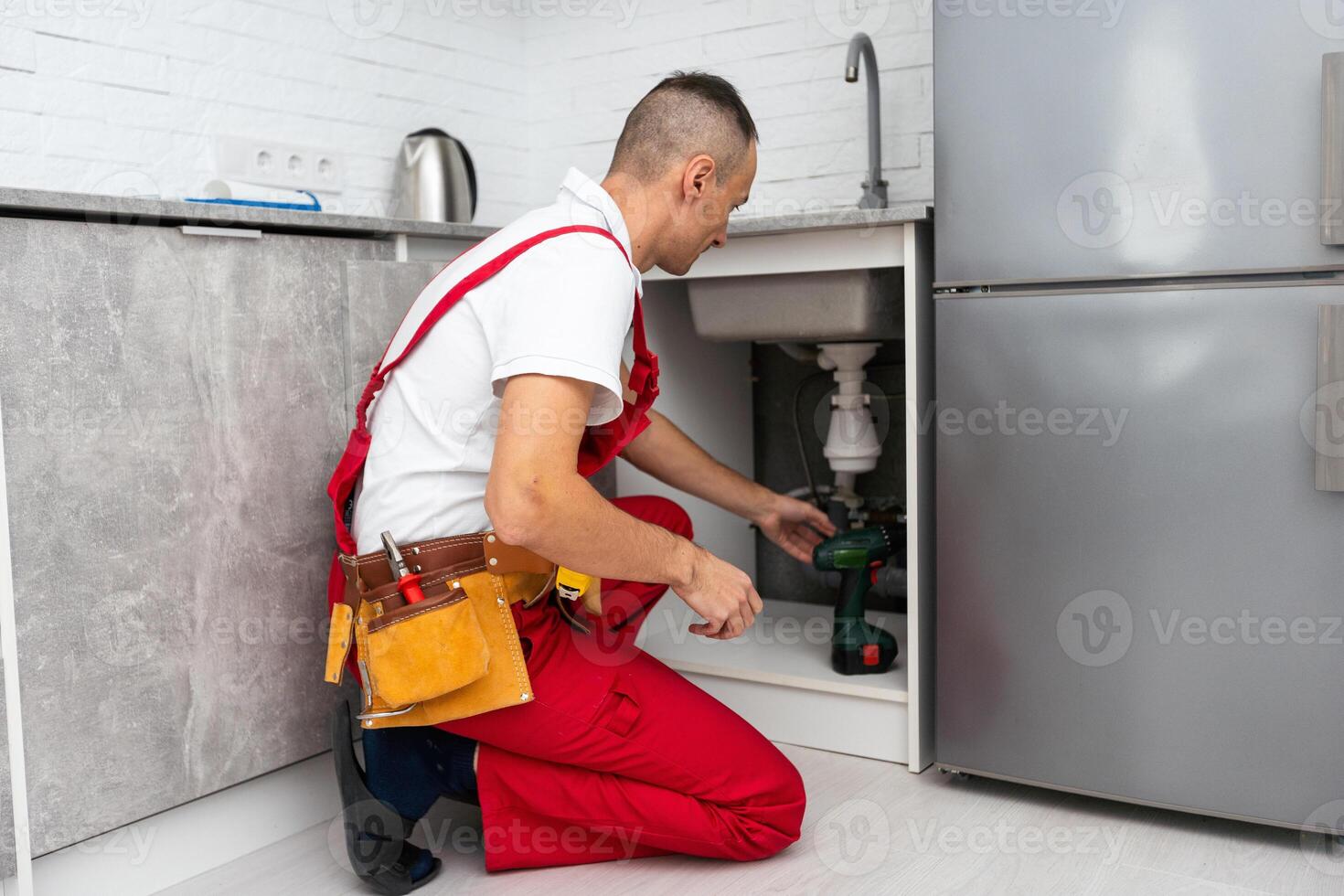 Plumber man fix repair service wraps fluoroplastic sealing material tape around faucet hose. Concept install plumbing in bathroom. photo