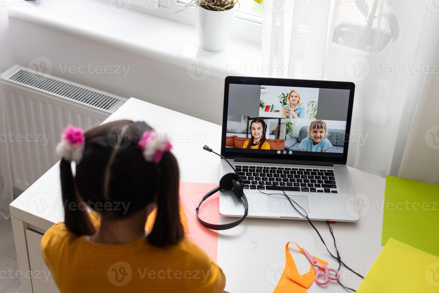 Online remote learning. School kids with computer having conference chat with teacher and class group. Child studying from home. Homeschooling during quarantine and coronavirus outbreak photo