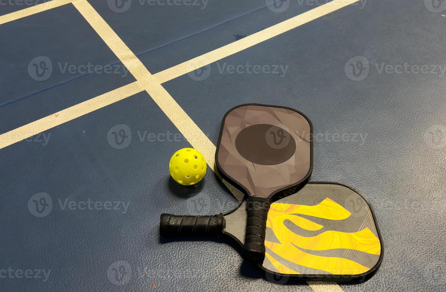 Pickleball Paddle and pickle ball of court. photo