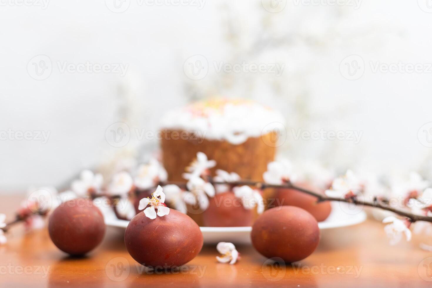 Easter cake, painted egg and blooming branch, spring composition on wooden table photo
