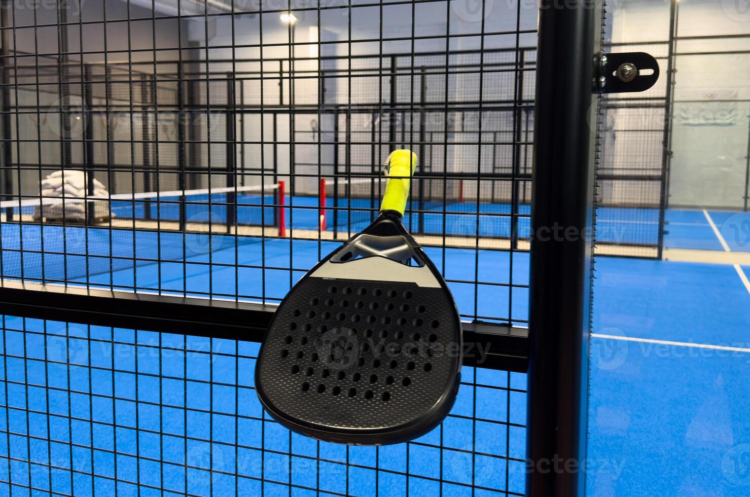 padel racket on a padel court with a ball photo