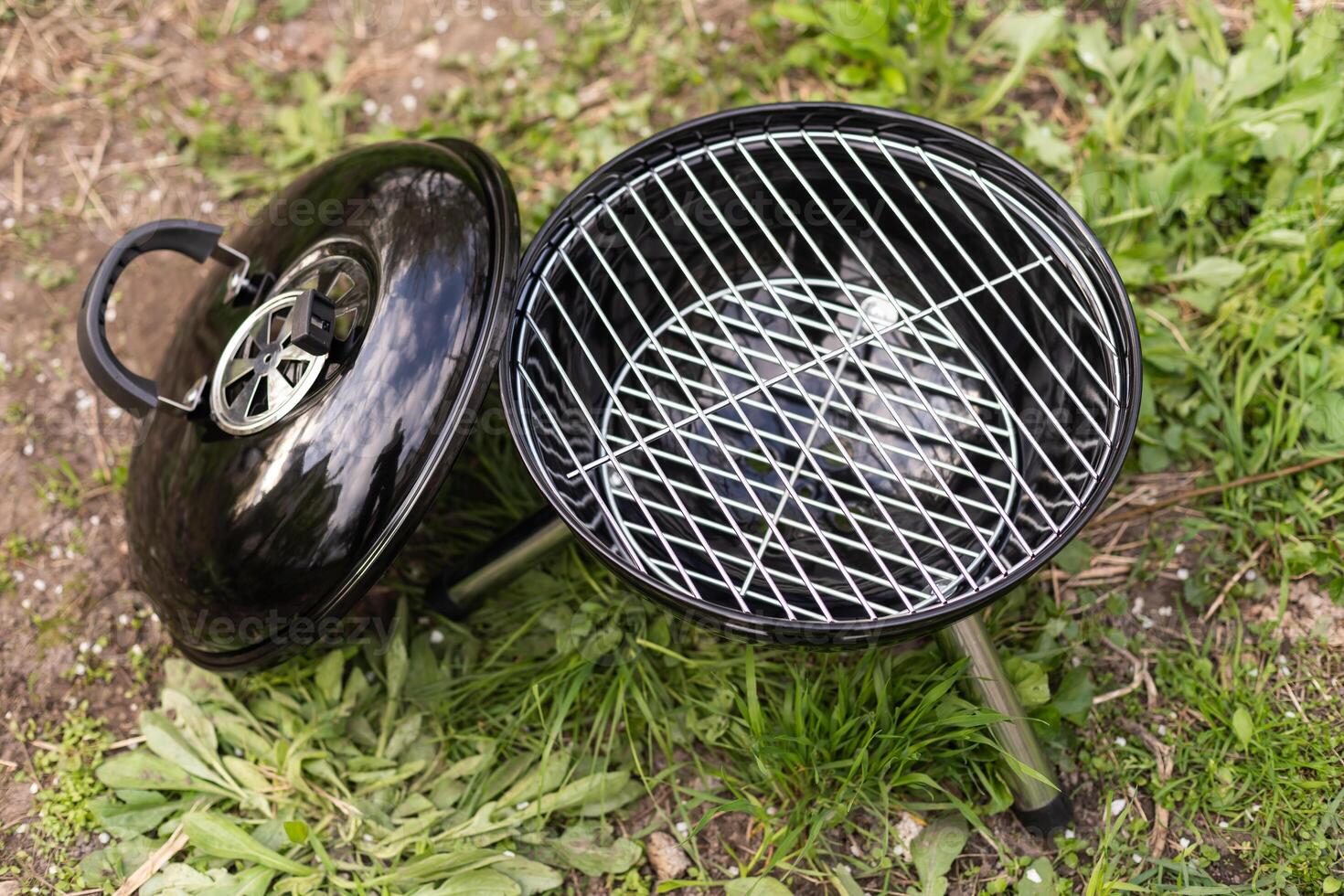 Empty Barbecue Grill Close-up In The Backyard Lawn At Summer. photo