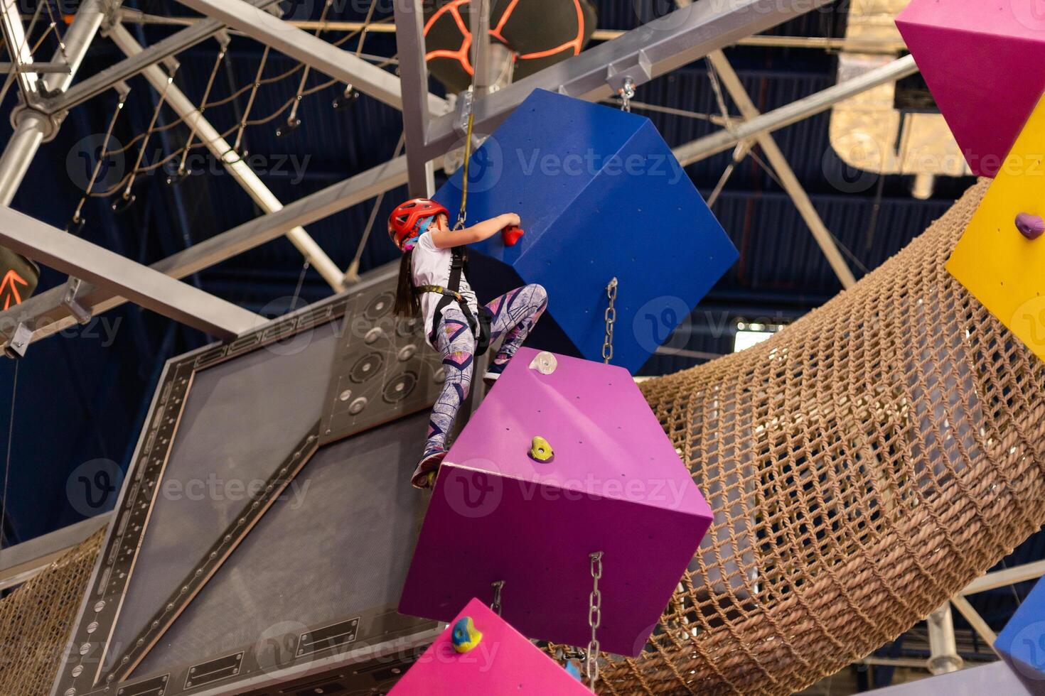 Little Girl Climbing Rock Wall photo