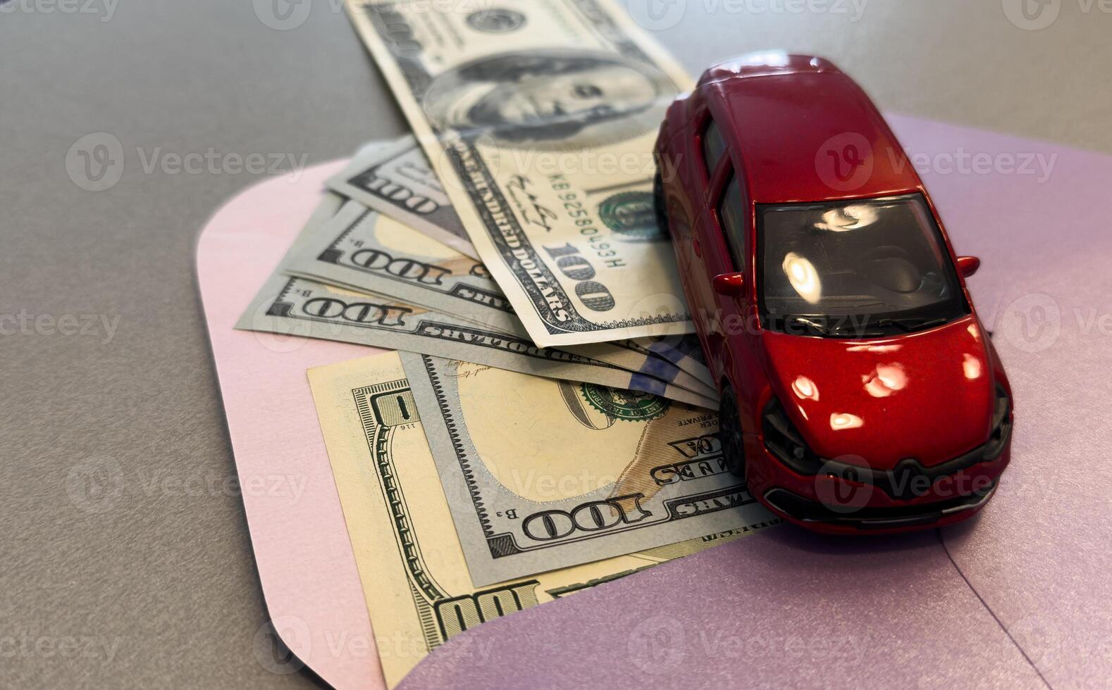 Toy car on a background of 100 dollar bills photo
