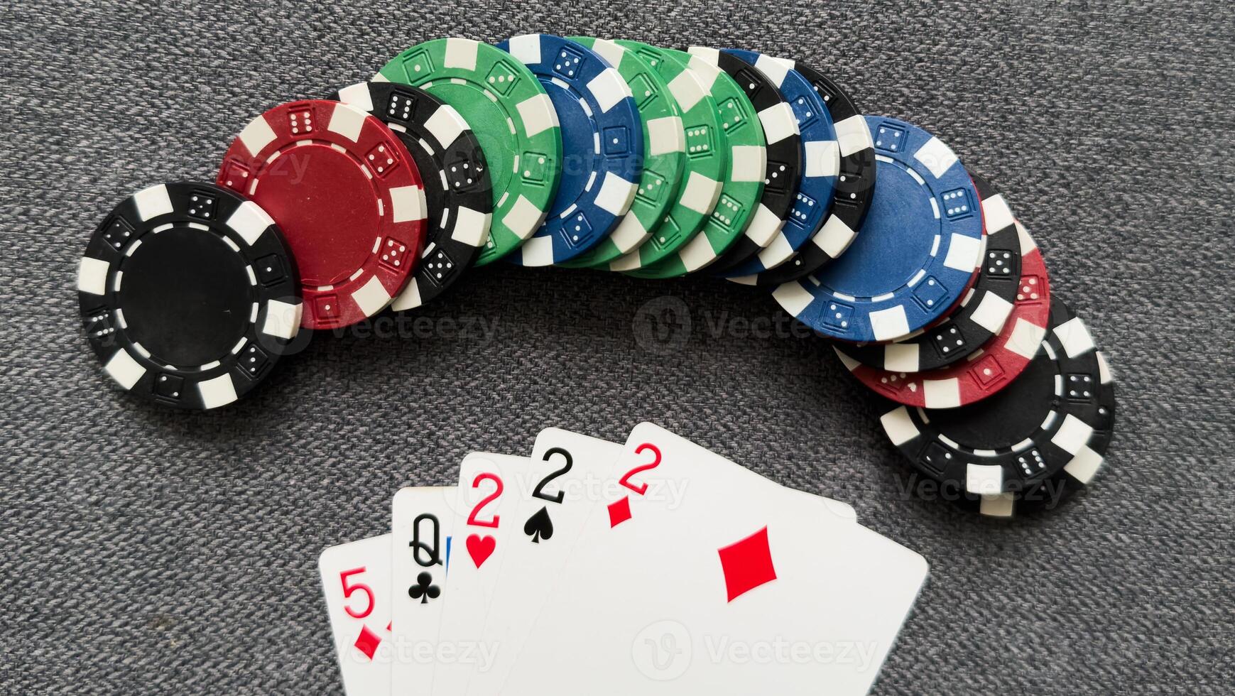 Poker cards and gambling chips on green background photo