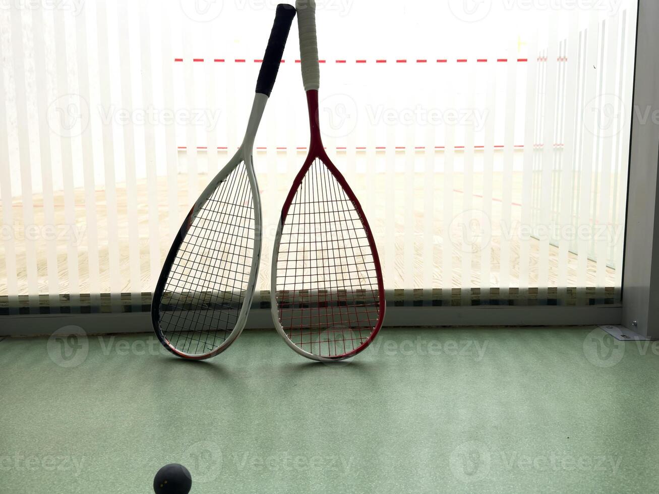 Empty squash court and rackets on the wooden floor. photo