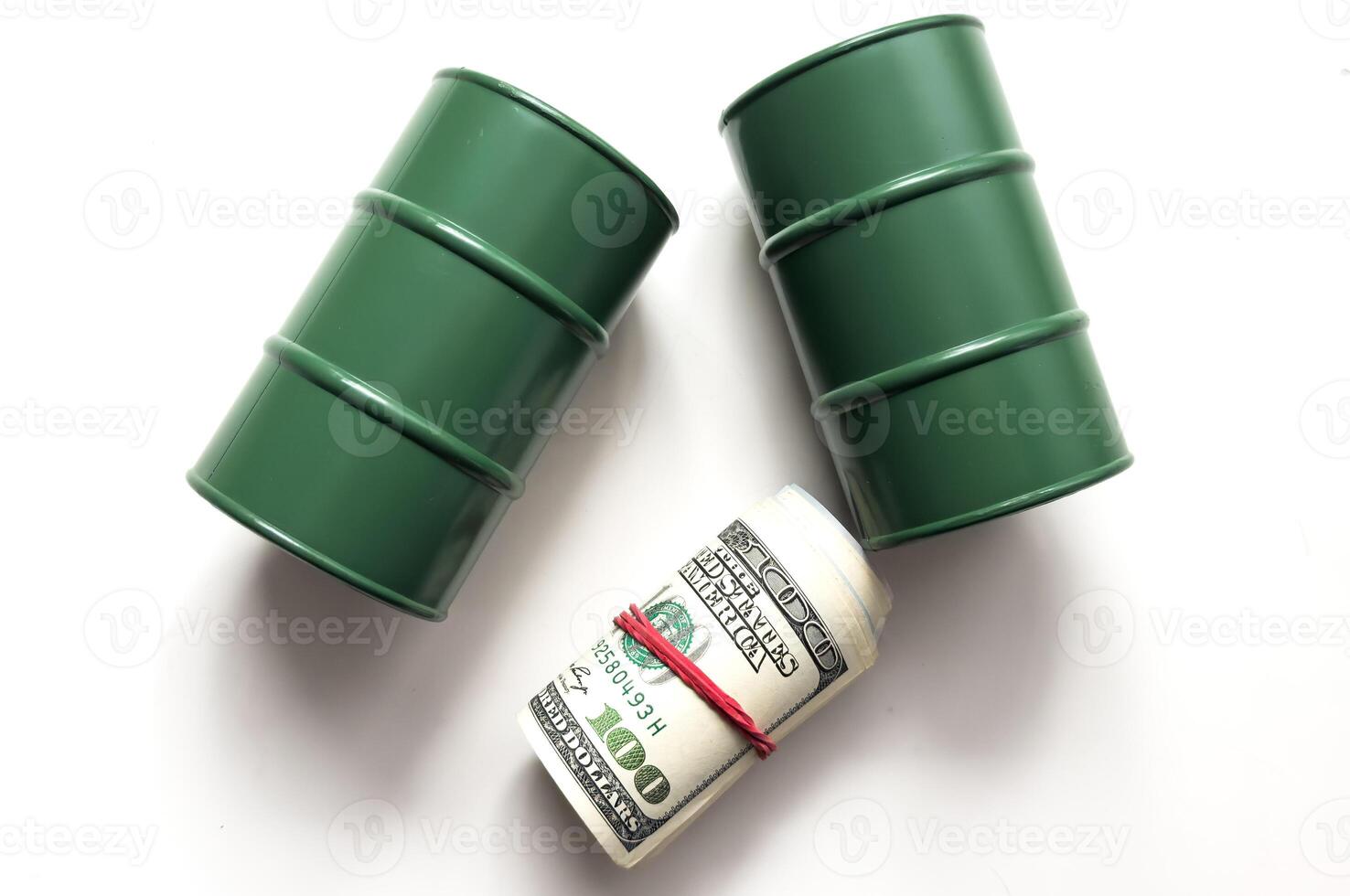 Petroleum, petrodollar and crude oil concept . Pump jack and a black barrel on US USD dollar notes, depicts the money received or earned from sales after investment in the development of oil industry. photo