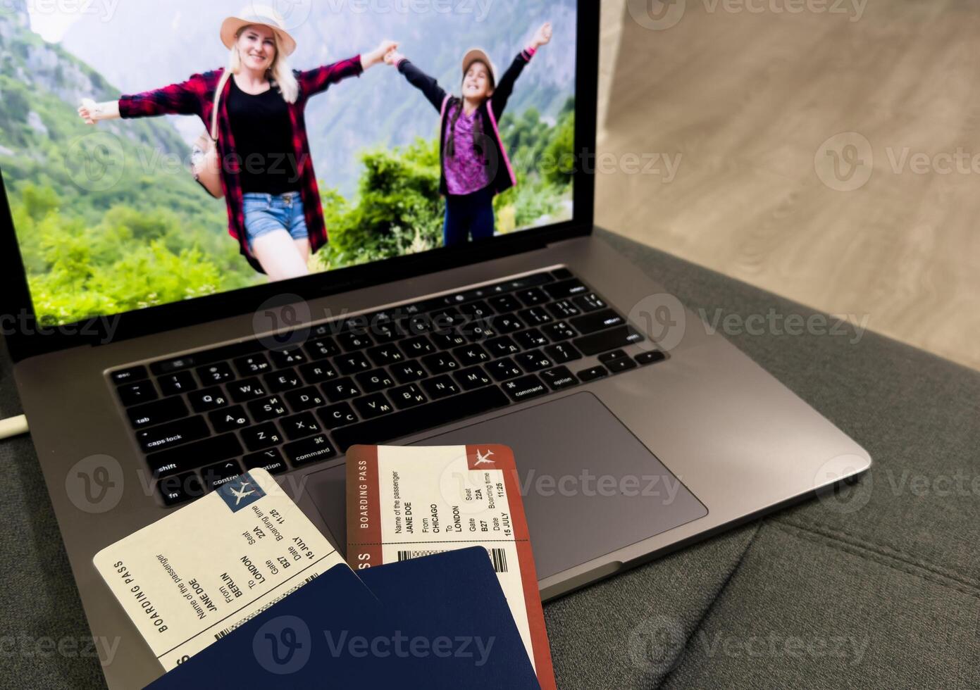Airline boarding passes with passport, laptop photo