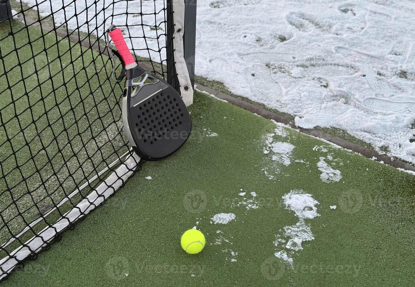 A tennis padel court covered in the snow, sport cancelled due to inclement weather. photo