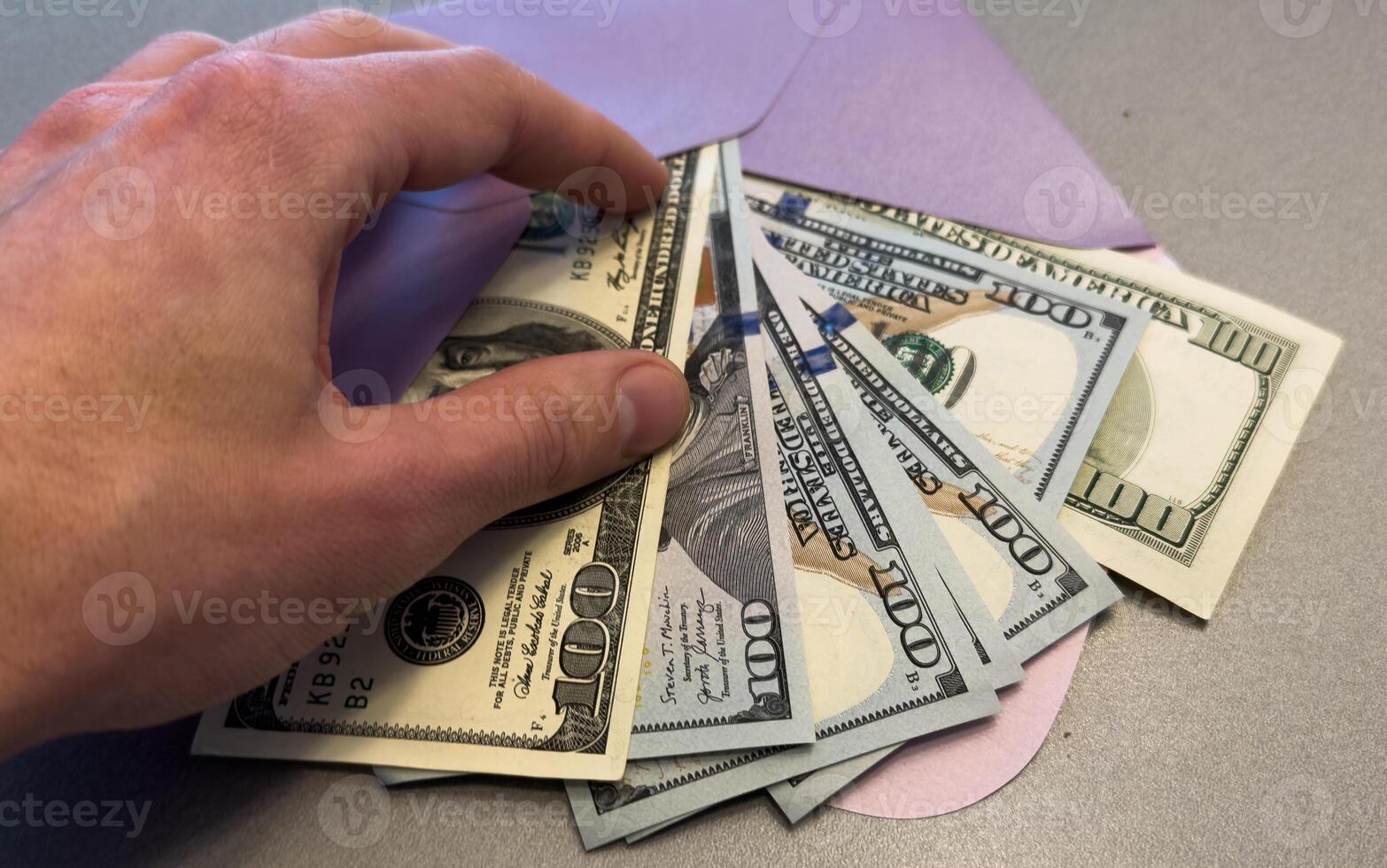 Money in envelope. US dollars in a brown envelope on a white background. The concept of income, bonuses or bribes. Corruption, salary, bonus. photo