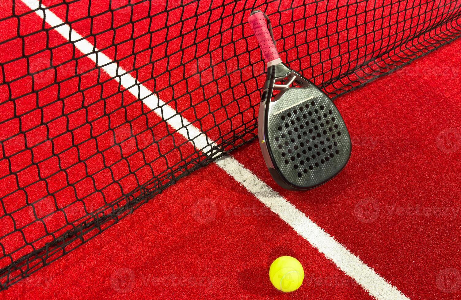 professional paddle tennis racket with natural lighting on red background. Horizontal sport theme poster, greeting cards, headers, website and app photo