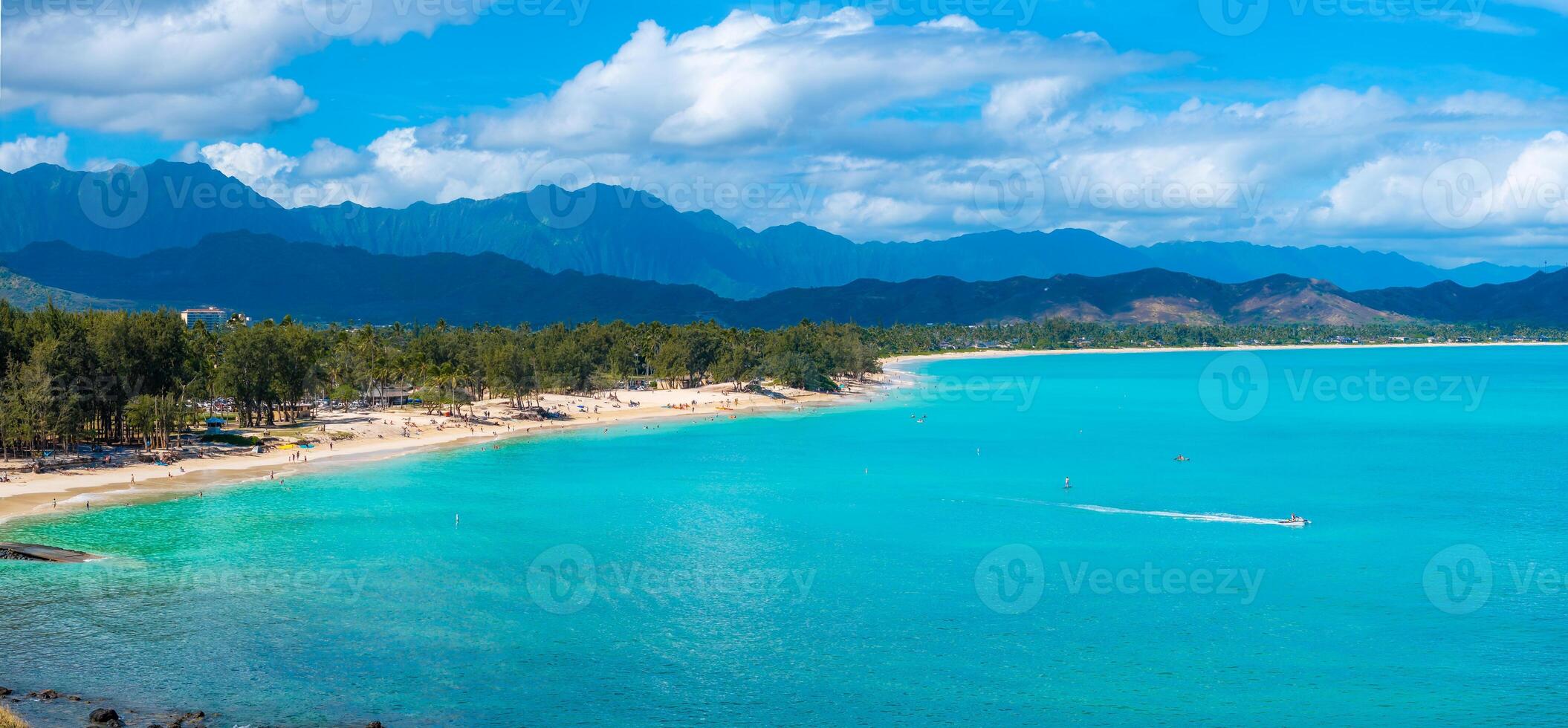 Aerial view of a beach on Oahu island, Hawaii, with turquoise waters, sandy shoreline, lush greenery, Ko olau mountains, and visitors enjoying the scene. photo