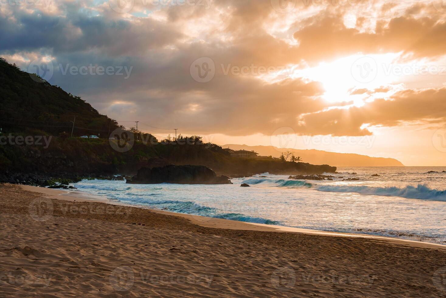 Sunset Beach Scene with Cliffs and Lush Greenery in Hawaii photo