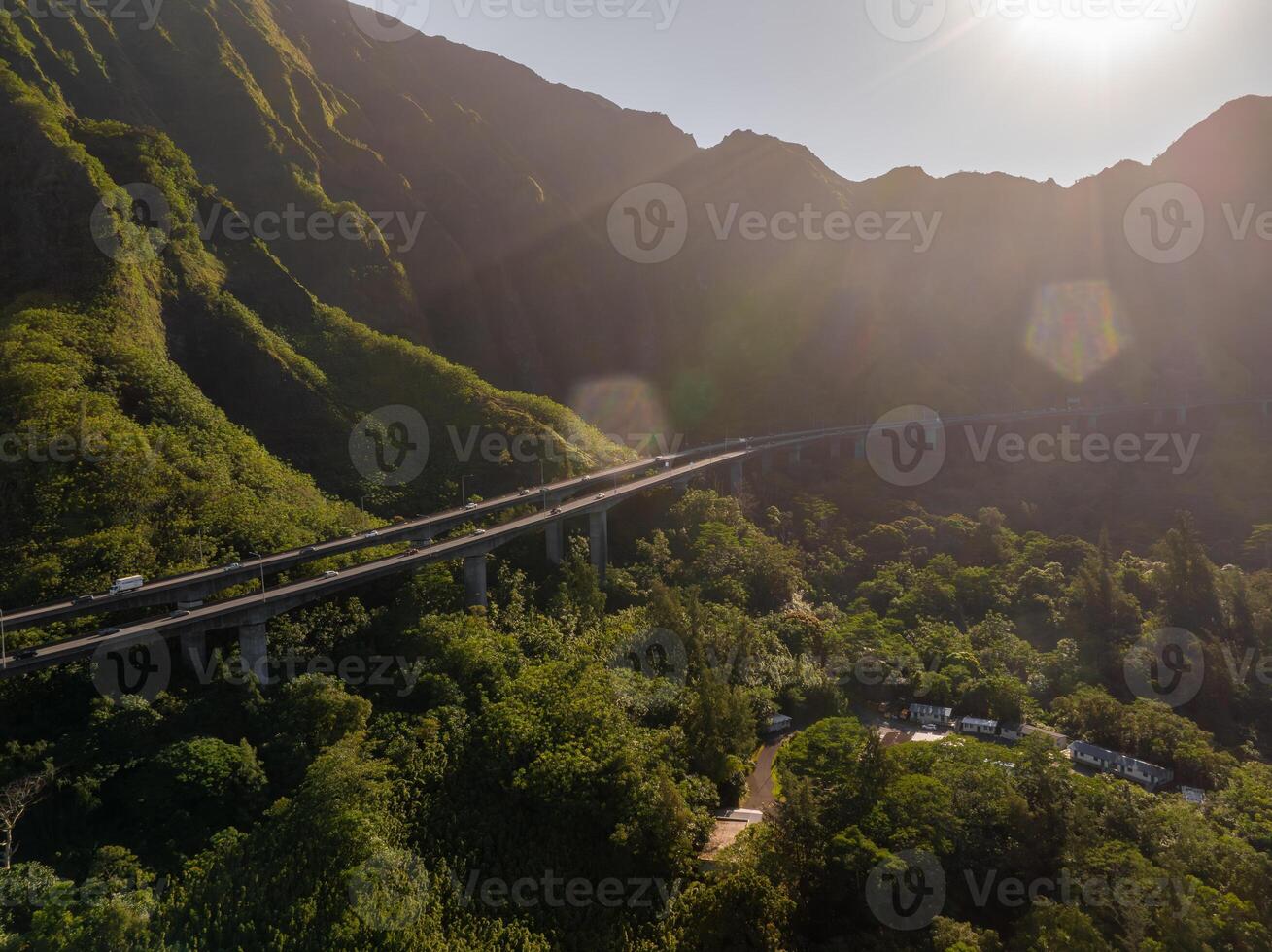 Aerial View of Highway Bridge Through Lush Mountains in Oahu, Hawaii photo