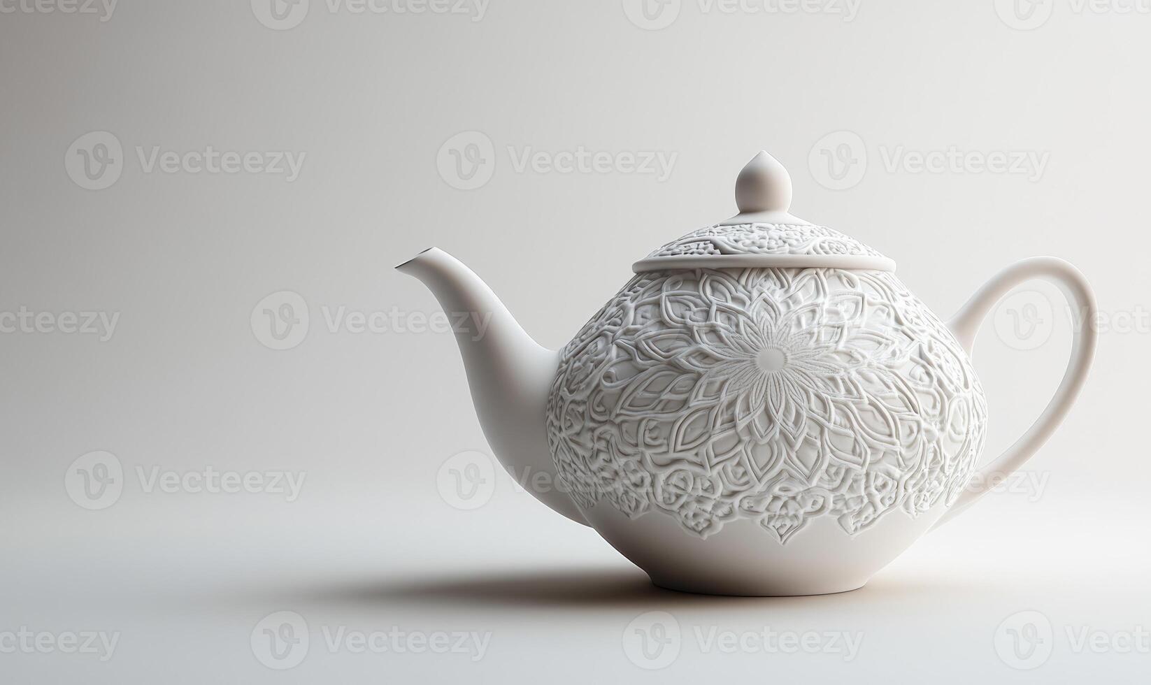 A white tea pot with a floral design sits on a white background photo