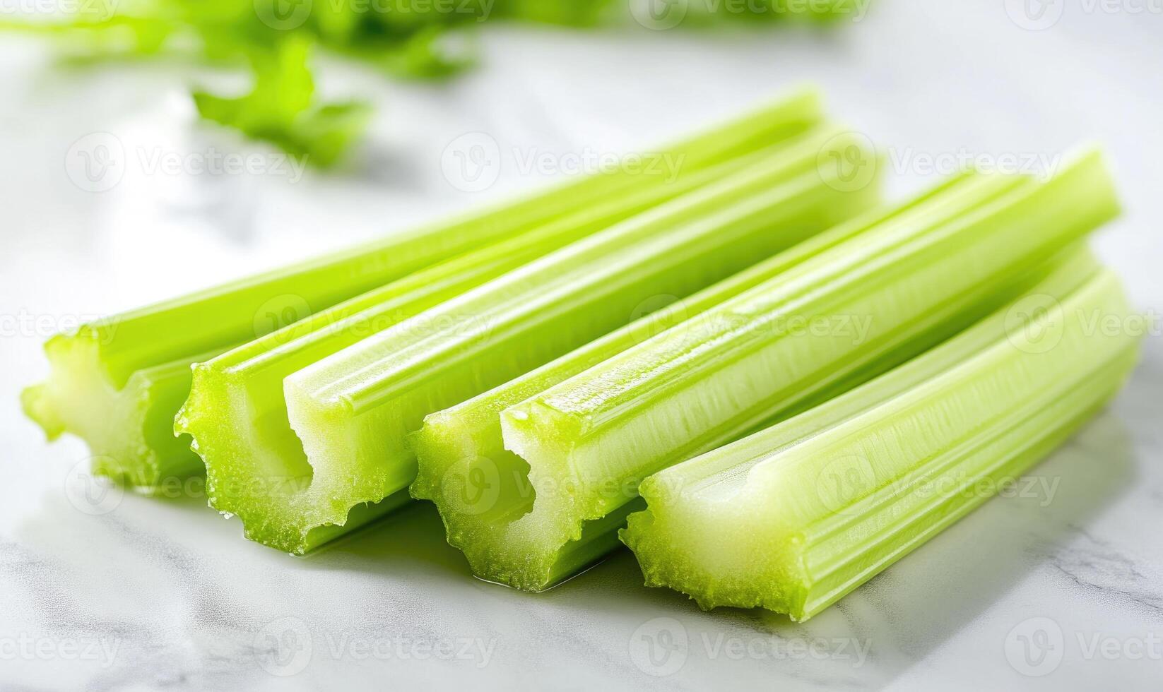 A bunch of celery sticks are on a white table photo