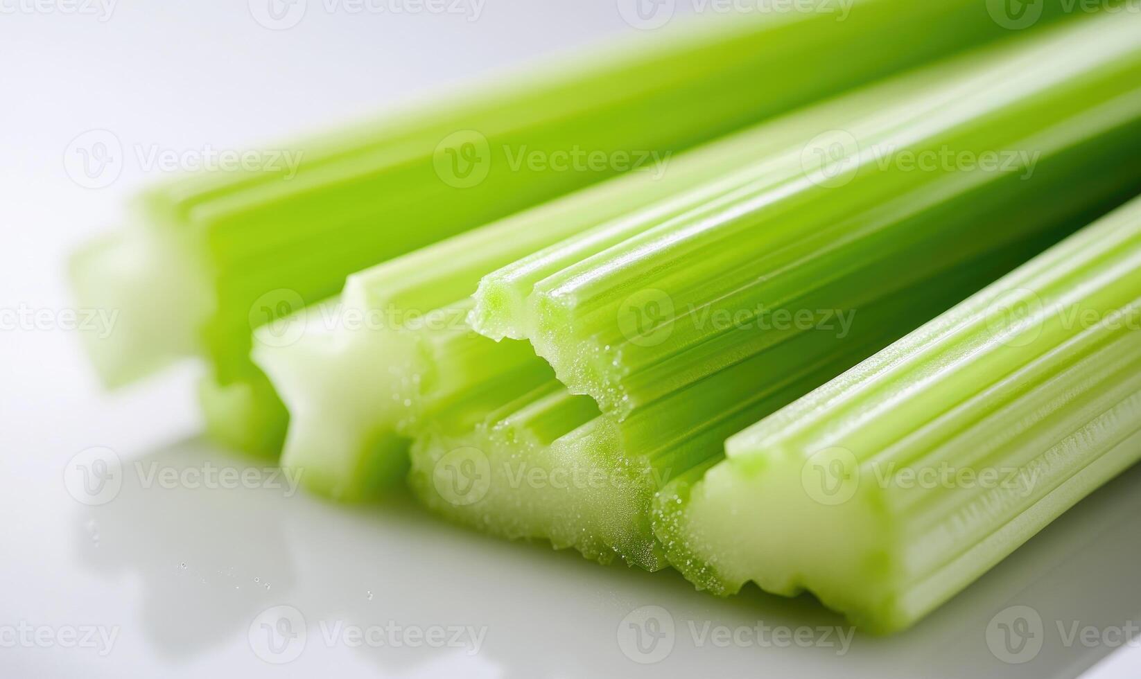 A bunch of celery sticks are on a white plate photo