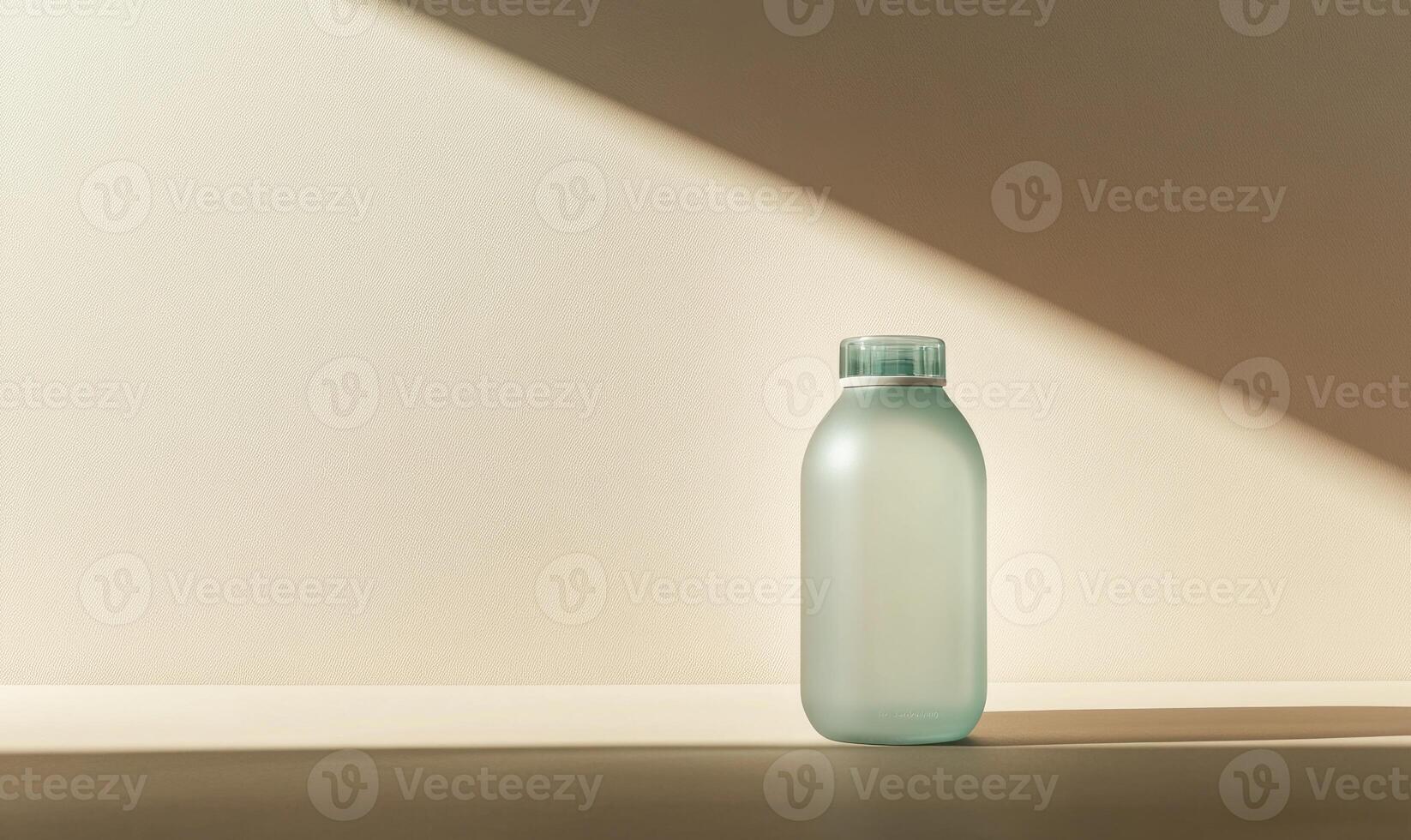 A clear bottle with a green cap sits on a white surface photo