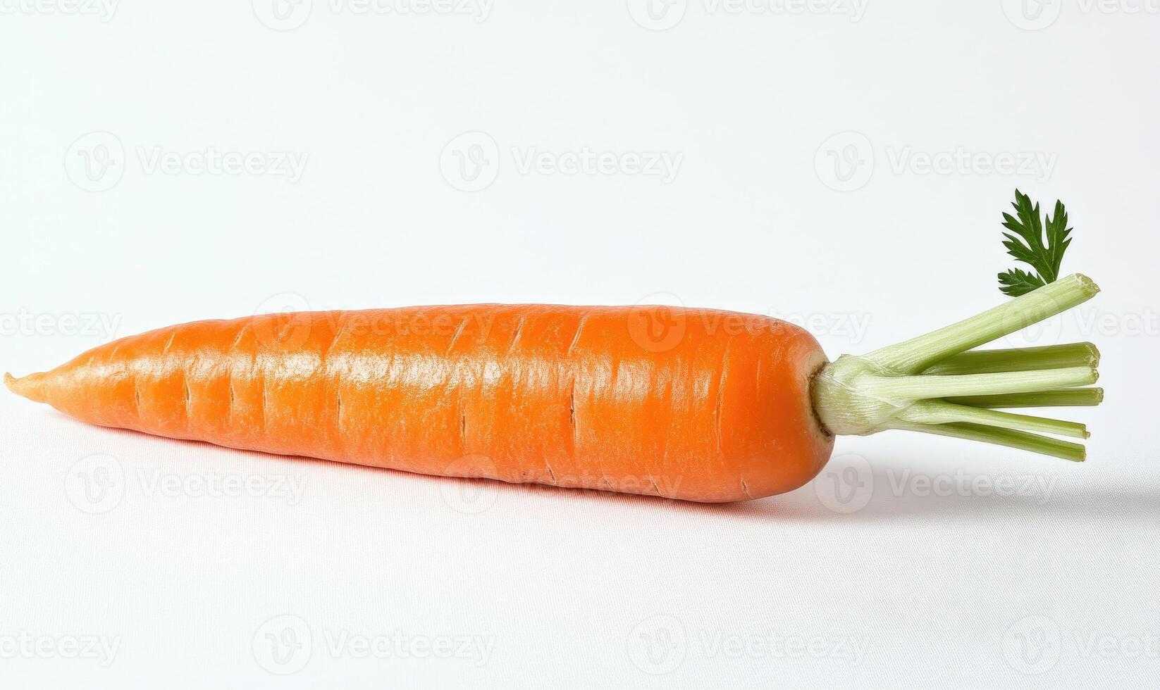 A carrot is shown with its green top photo