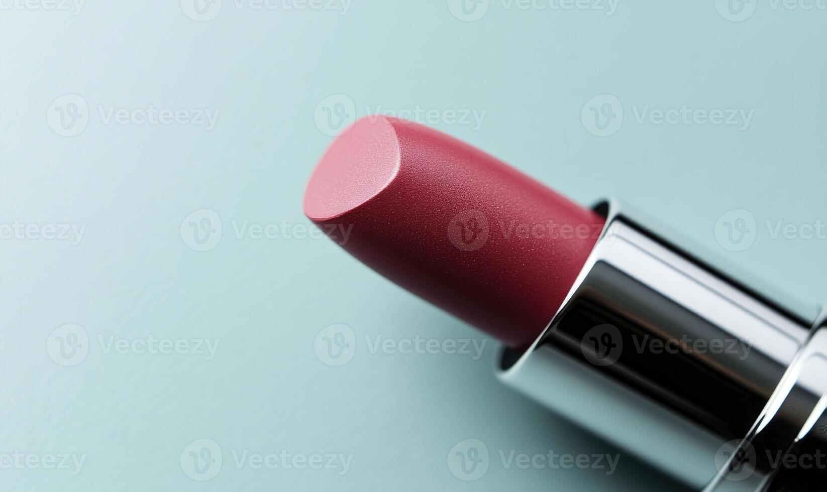 A lipstick is shown with a silver cap photo