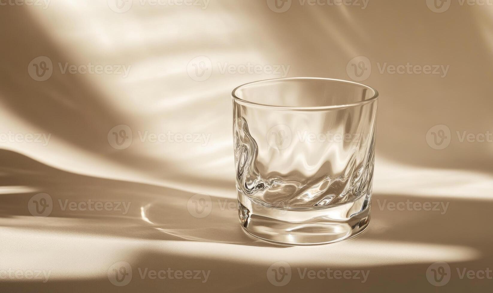 A glass is sitting on a table photo