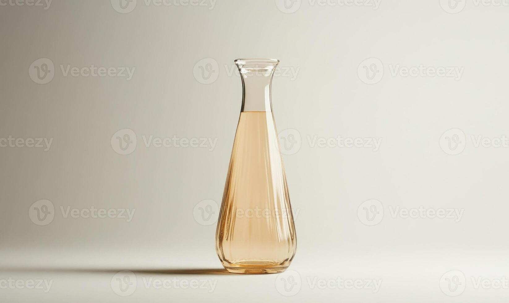 A tall glass vase with a yellowish color photo