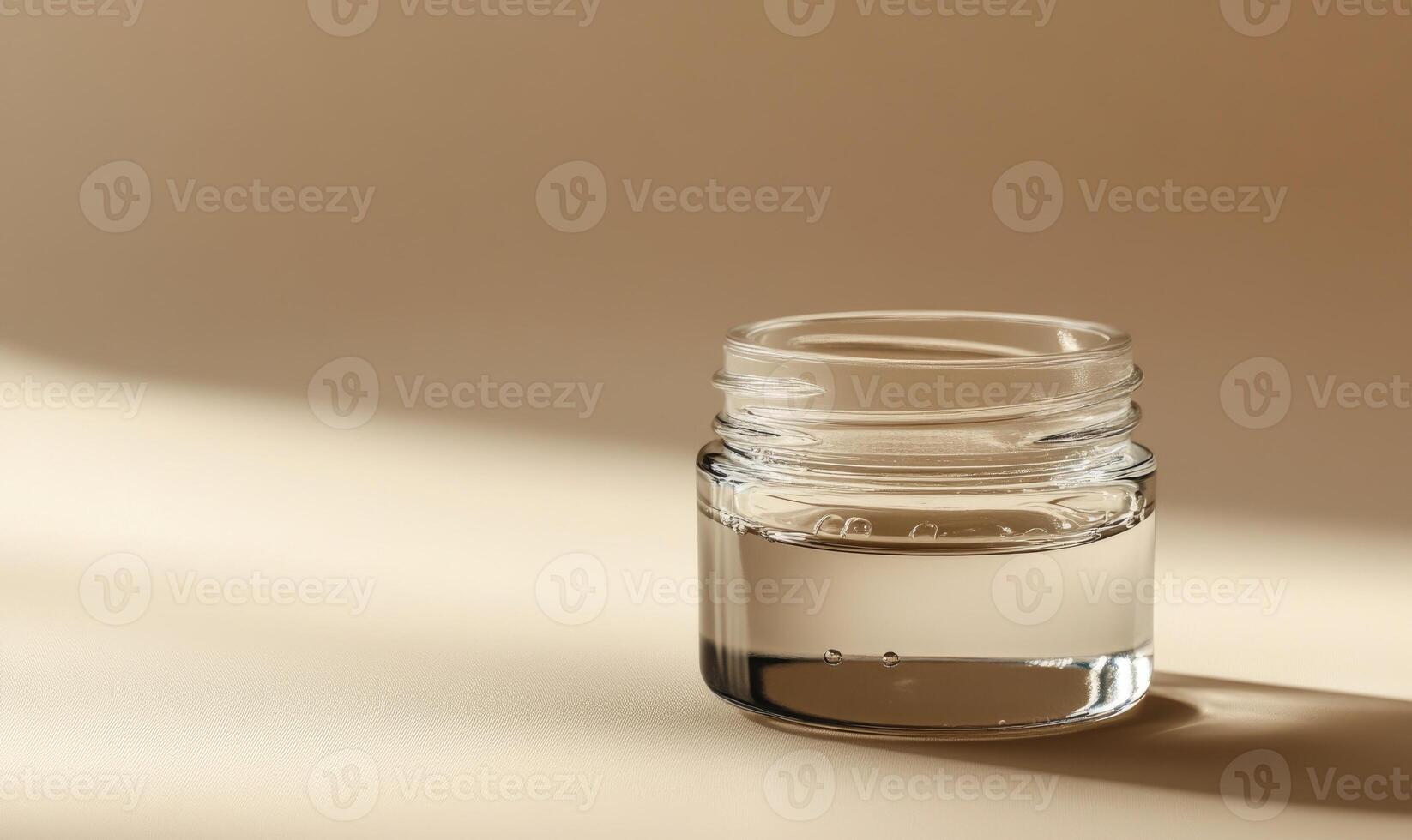 A clear jar with a lid is sitting on a table photo