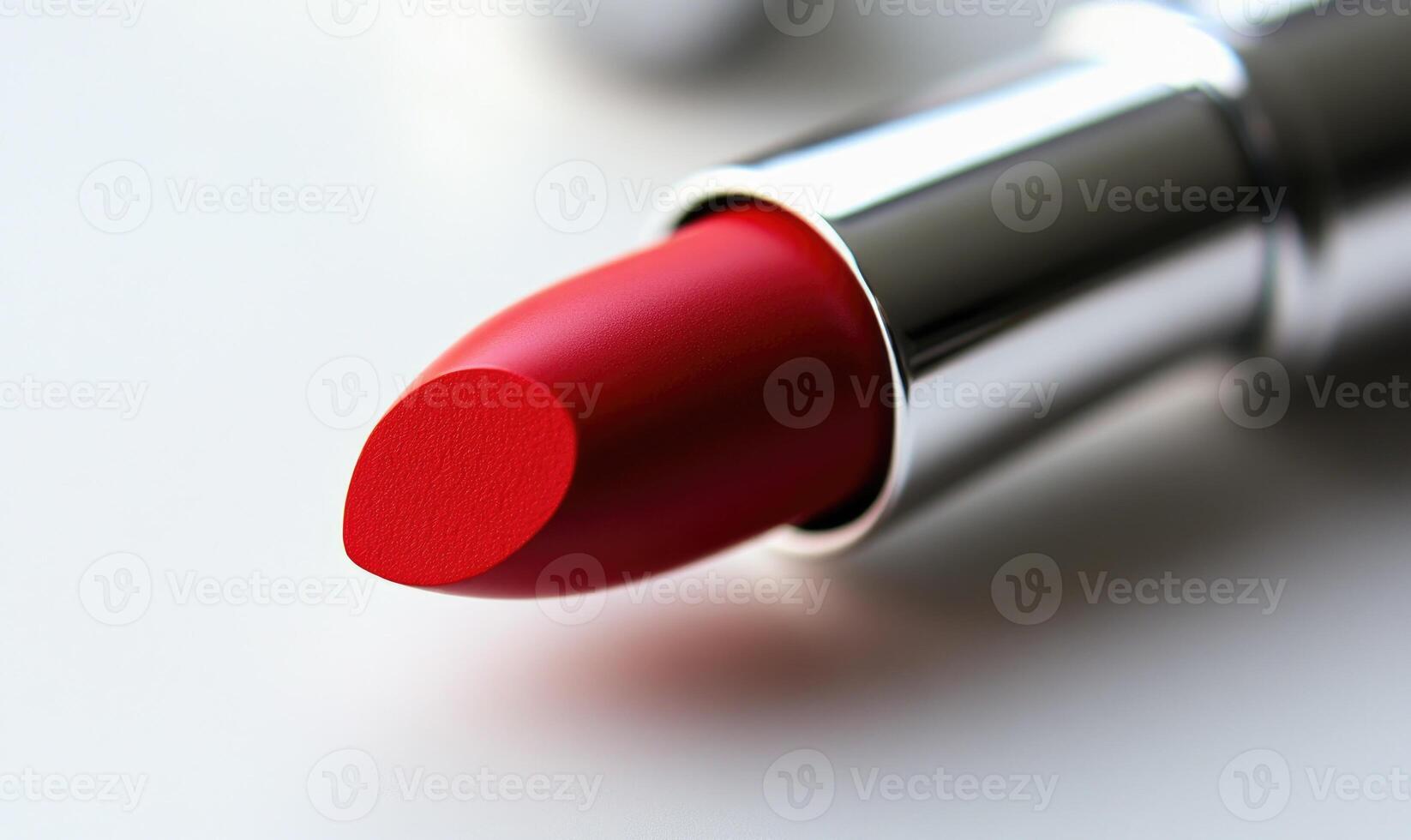 A red lipstick is shown with a silver cap photo