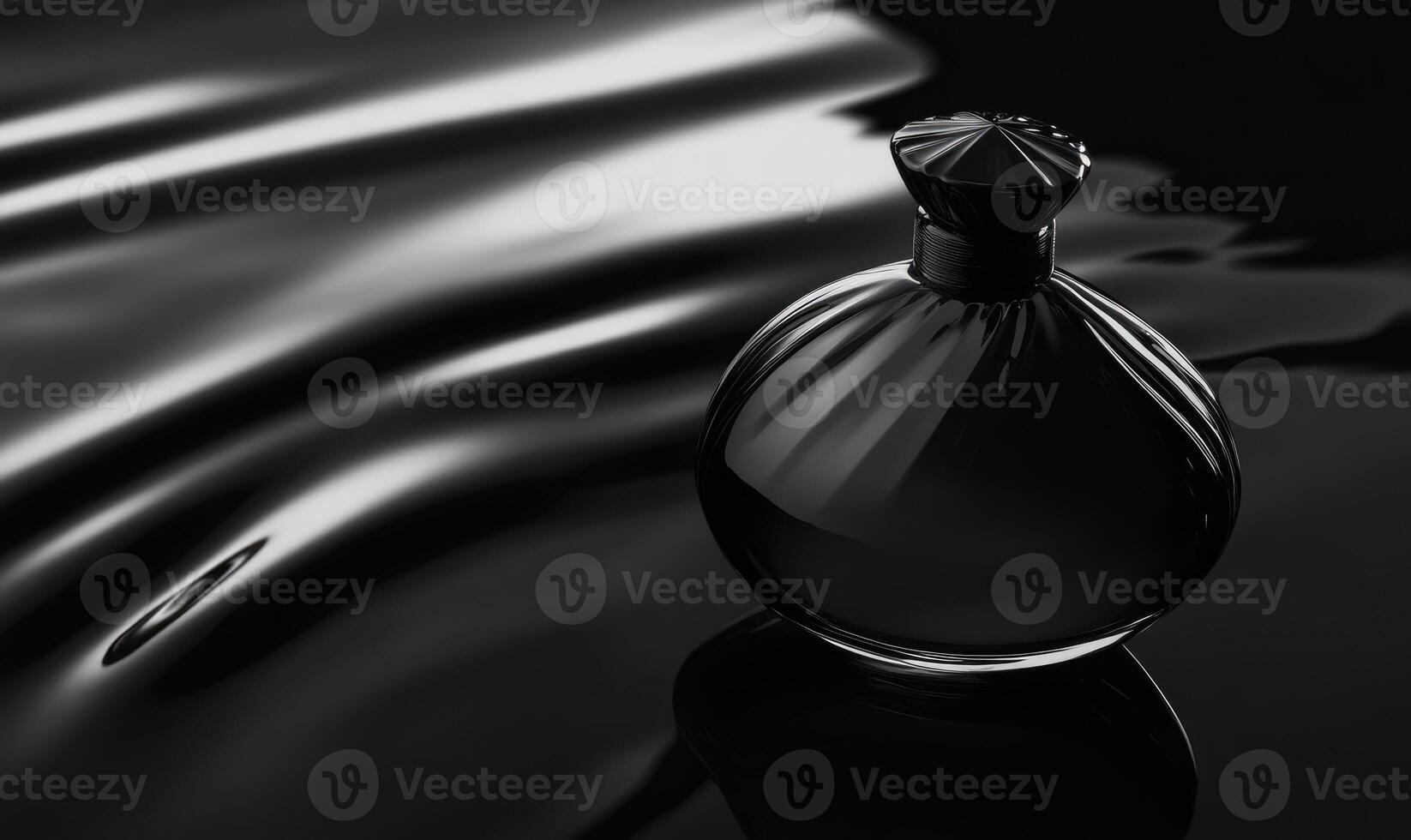 A bottle of perfume is sitting on a dark surface photo