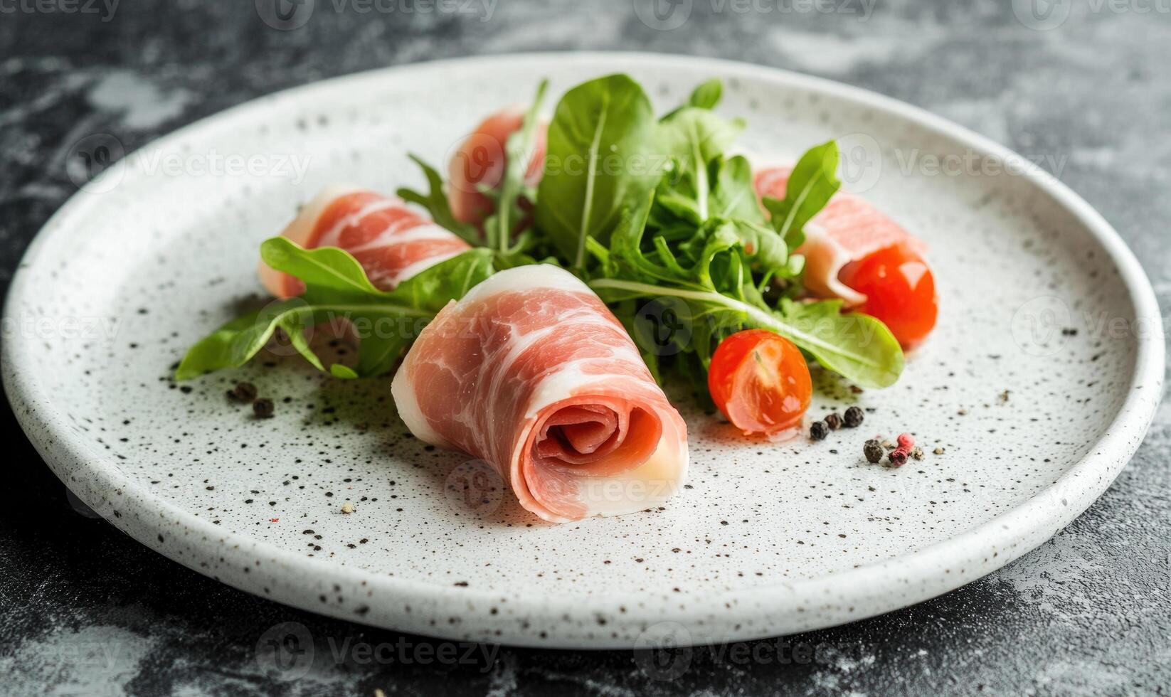 A plate of ham and greens with a tomato on top photo