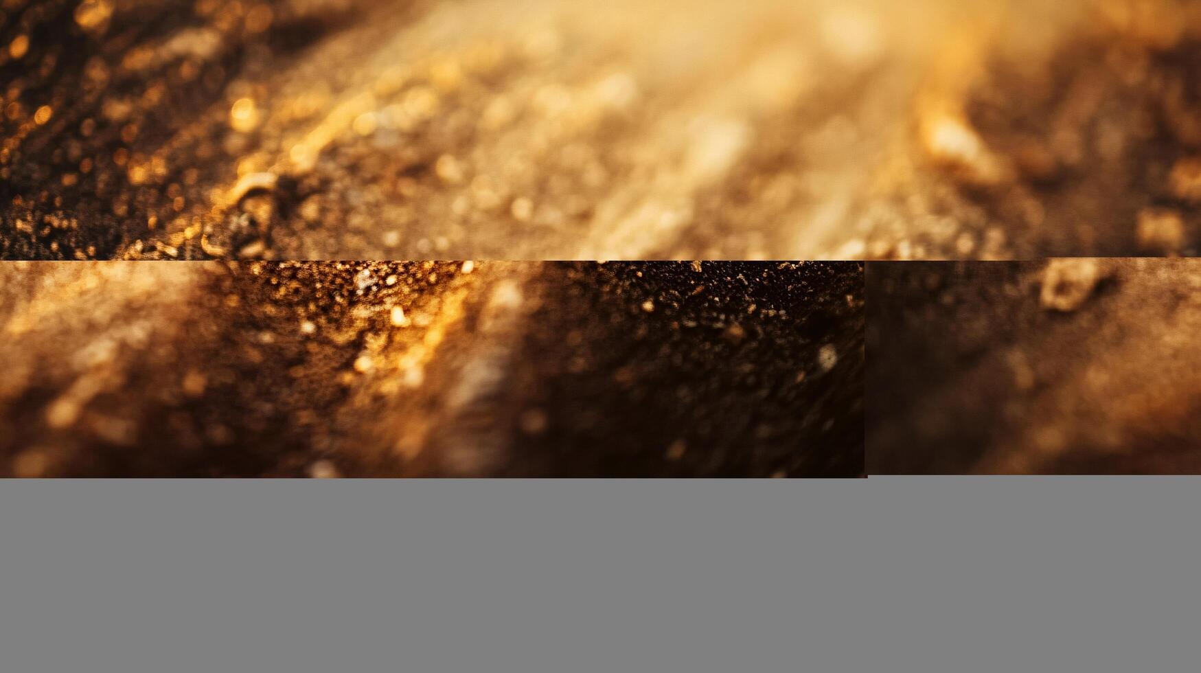 A close up of a sandy surface with a gold tint photo