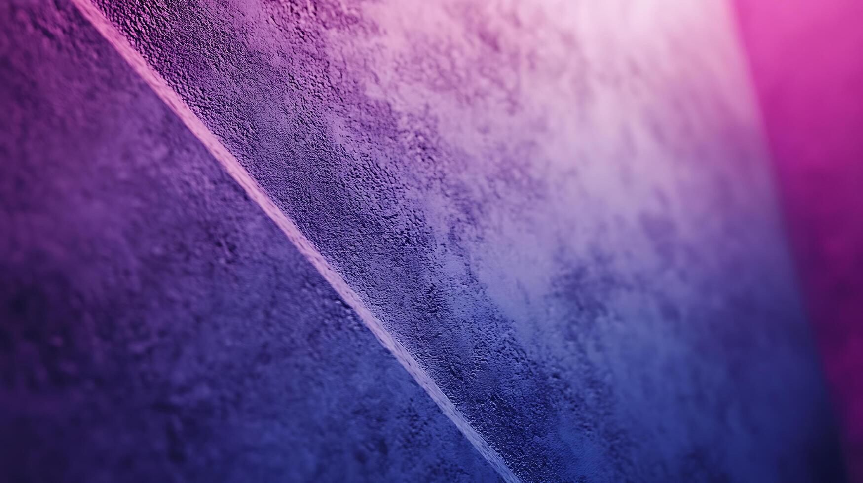 Textured surface with a dividing line, transitioning from deep purples and blues to soft pinks, conveying depth and subtle gradient. photo