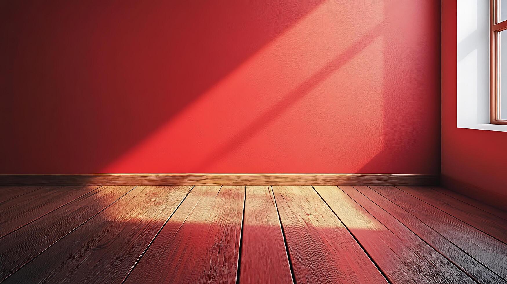 Warm sunlight graces the deep red wall and wooden floors of this contemporary room, creating a serene and inviting atmosphere. photo