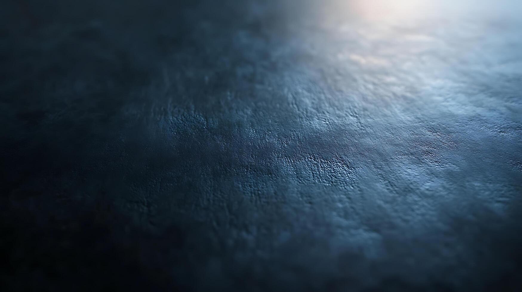 Textured surface in dark blues and grays with a shallow depth of field, creating a dreamy, ethereal effect. Abstract, minimalist art. photo
